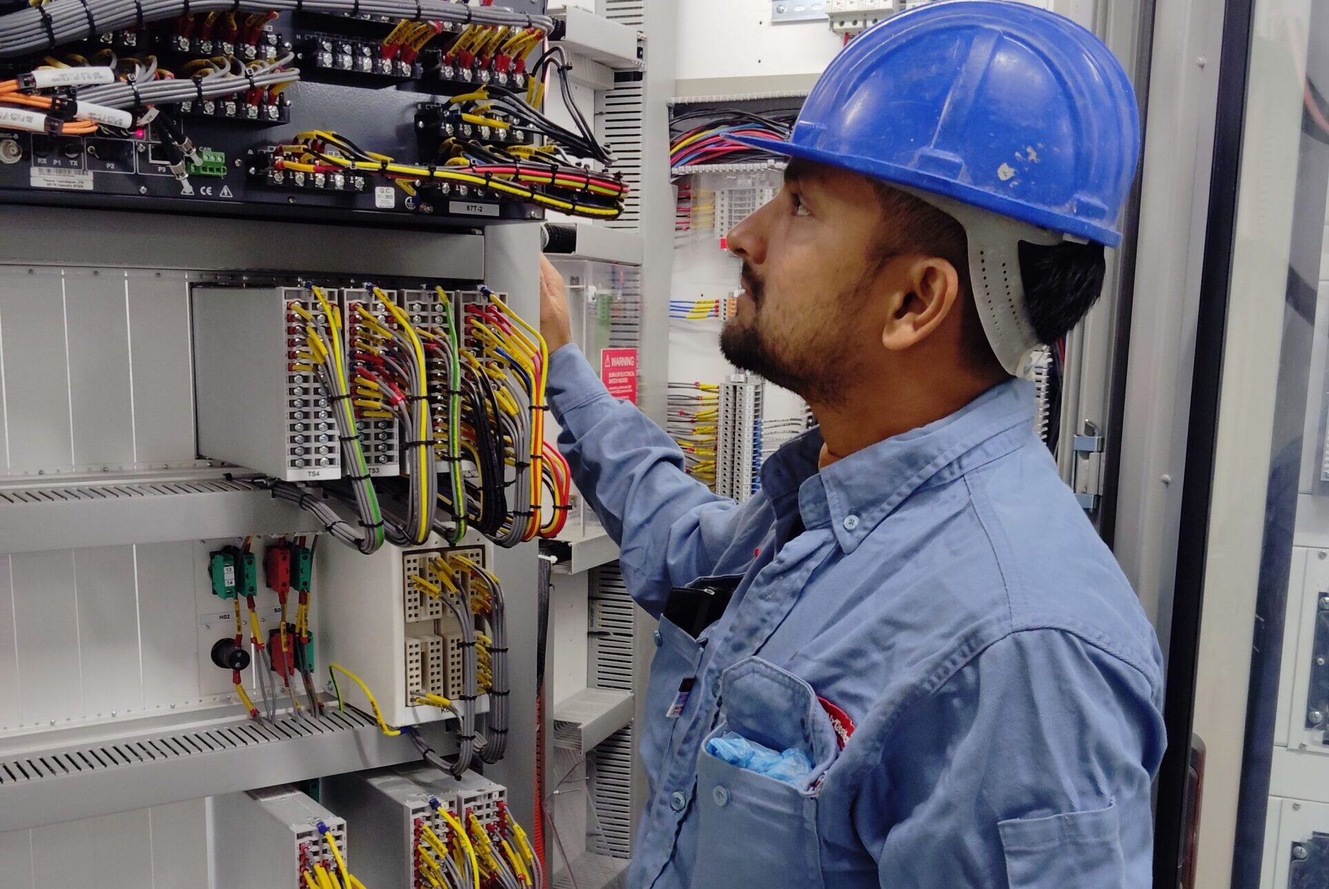 Engineer working on electrical control equipment